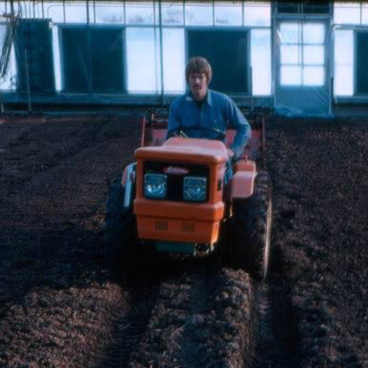 A guy driving a tractor.